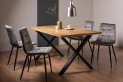 The Bentley Designs Ramsay Rustic Oak Effect Melamine 6 Seater Dining Table with X Leg & 4 Mondrian Grey Velvet Fabric Chairs with Sand Black Powder Coated Legs