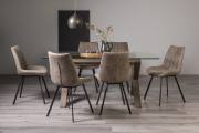 The Bentley Designs Turin Clear Tempered Glass 6 Seater Dining Table with Dark Oak Legs & 6 Fontana Tan Fax Suede Fabric Chairs with Grey Hand Brushing on Black Powder Legs Black Powder Coated Legs