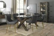 The Bentley Designs urin Clear Tempered Glass 6 Seater Dining Table with Dark Oak Legs & 6 Cezanne Dark Grey Faux Leather Chairs with Matt Gold Plated Legs