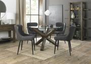 The Bentley Designs Turin Clear Tempered Glass 4 Seater Dining Table with Dark Oak Legs & 4 Cezanne Dark Grey Faux Leather Chairs with Sand Black Powder Coated Legs