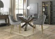The Bentley Designs Turin Clear Tempered Glass 4 Seater Dining Table with Dark Oak Legs & 4 Cezanne Grey Velvet Fabric Chairs with Matt Gold Plated Legs