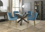 The Bentley Designs Turin Glass 4 Seater Dining Table with Dark Oak Legs & 4 Cezanne Petrol Blue Velvet Fabric Chairs with Matt Gold Plated Legs