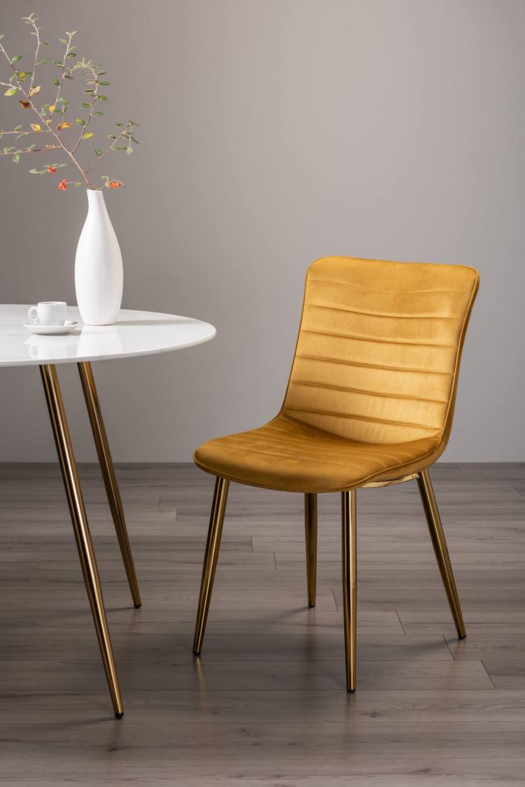 The Bentley Designs Rothko Mustard Velvet Fabric Chair on Display 