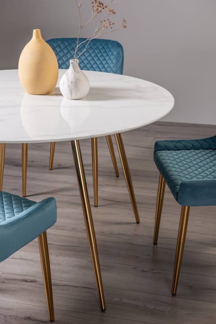 Close up of the Bentley Designs Francesca White Marble Effect Tempered Glass 4 Seater Dining Table & 4 Cezanne Petrol Blue Velvet Fabric Chairs with Matt Gold Plated Legs  