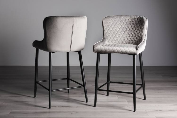 The Bentley Designs Cezanne Grey Velvet Fabric Bar Stools with Sand Black Powder Coated Legs (Pair) on Display