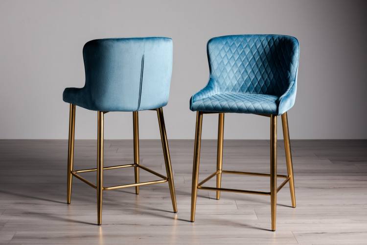 The Bentley Designs Cezanne Petrol Blue Fabric Bar Stools with Matt Gold Plated Legs (Pair) on Display