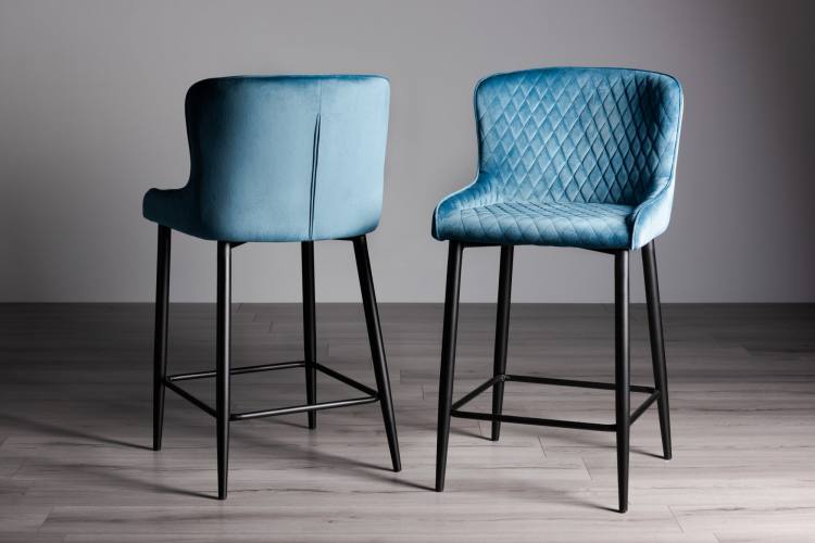 The Bentley Designs Cezanne Petrol Blue Velvet Fabric Bar Stool with Sand Black Powder Coated Legs (Pair) on Display