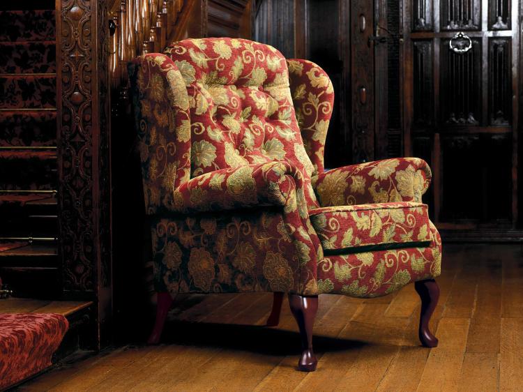 Pictured in a floral (discontinued) fabric with Queen Anne legs in a Dark finish