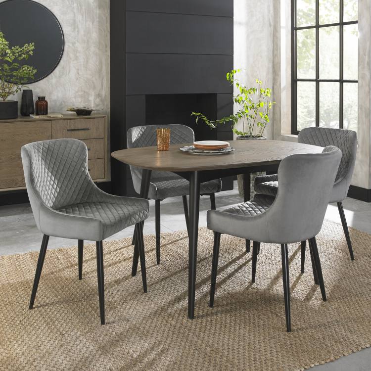 Bentley Designs Cezanne Grey Velvet Fabric Chair on Display with Dining Table 